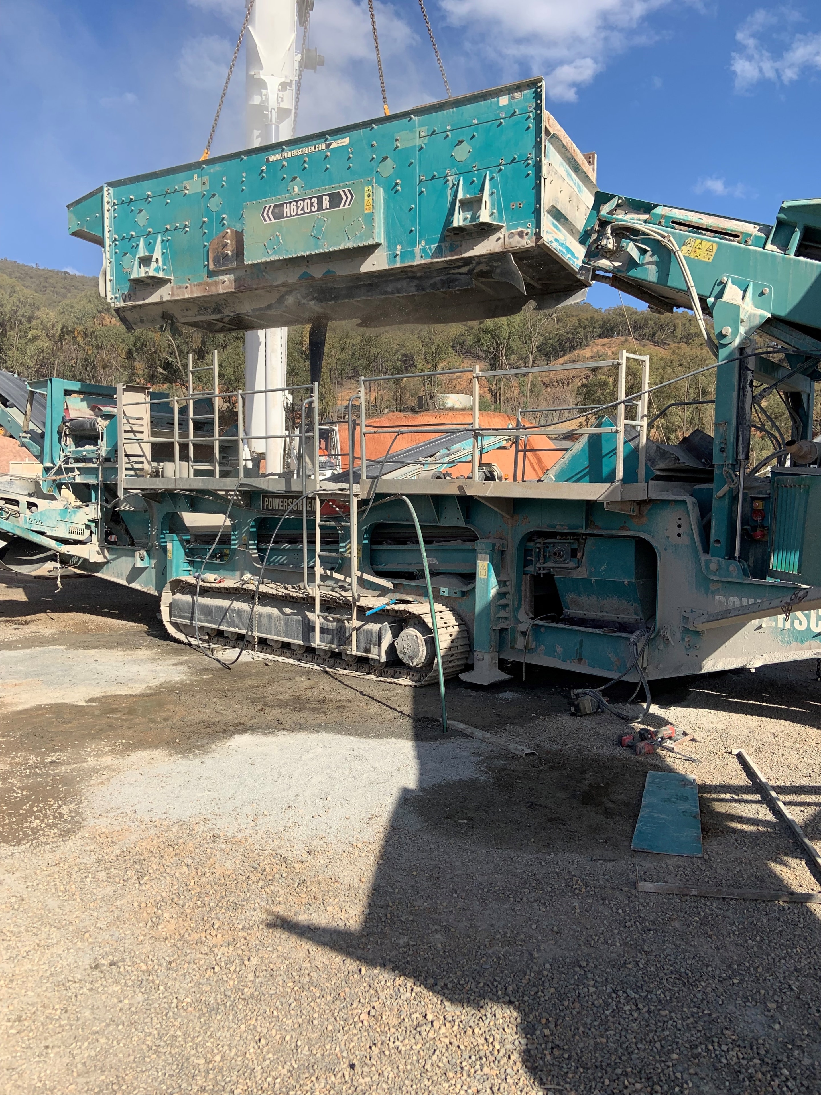 Industrial crane lifting metal container