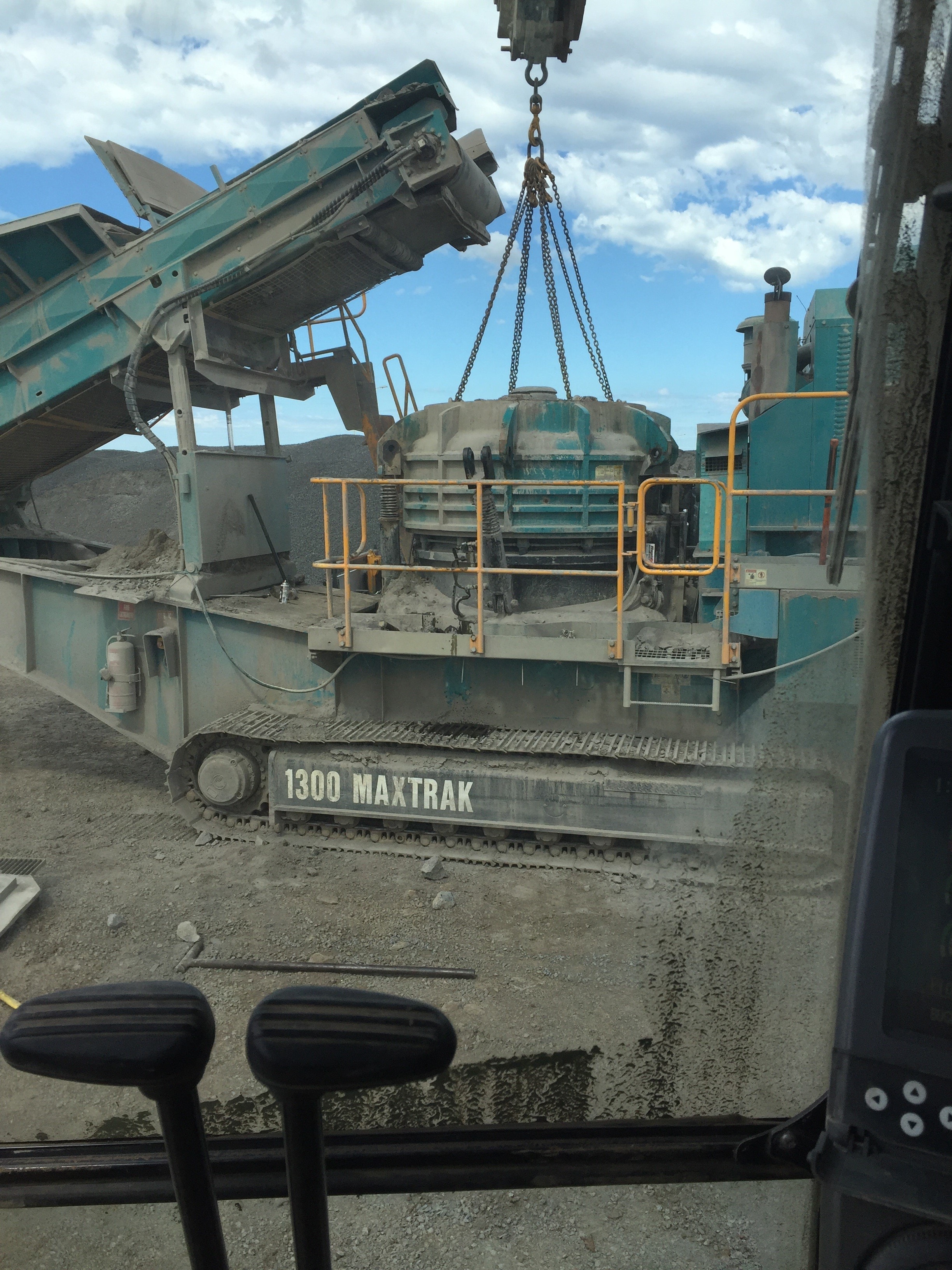 Cone crusher head being lifted at quarry site
