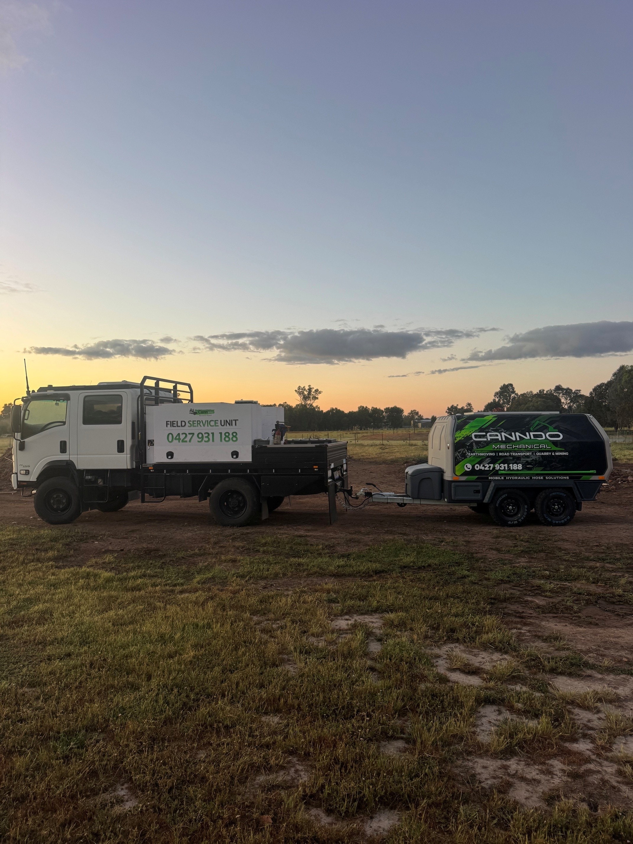 Canndo Mechanical field service unit truck and hydraulic hose trailer at sunset